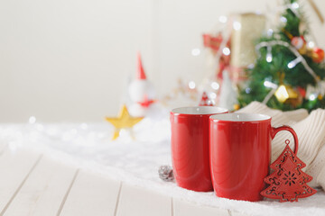 Couple red mugs on Christmas