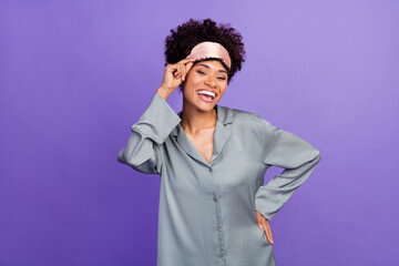 Photo of carefree beautiful woman grey sleepwear hand arm mask smiling isolated violet color...