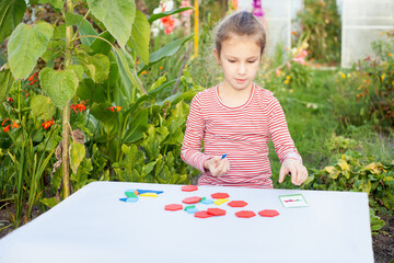 A girl on the street plays with a designer