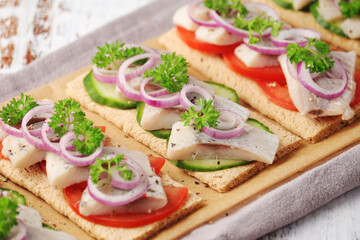 Sandwiches with herring and vegetables	