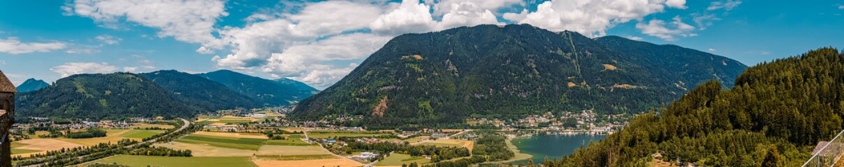 Fototapeta premium High resolution stitched panorama of a beautiful alpine summer view at the famous Landskron castle ruins, Villach, Kaernten, Austria