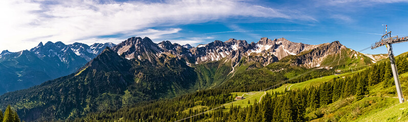 High resolution stitched panorama of a beautiful alpine summer view with the Kleinwalsertal in the background seen from the famous Fellhorn summit near Oberstdorf, Bavaria, Germany