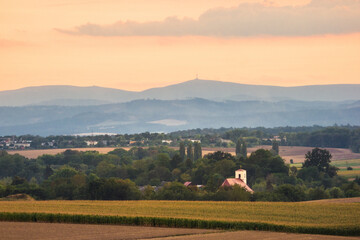 landscape in region country. Sunset over mounains and church