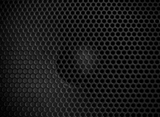 Protective decorative metal grill with honeycombs on modern acoustic systems. Music speakers close-up. Abstract background closeup, soft focus and beautiful bokeh.