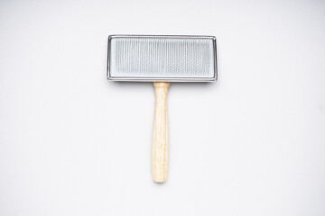 Grooming brush. Brush for dogs on a white background. Flat lay.