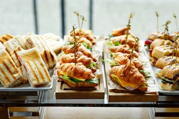 Zelfklevend Fotobehang Stacks of croissant sandwich at event. © 9parusnikov