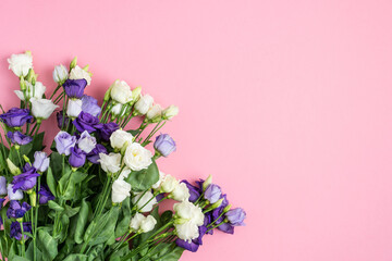 The composition of flowers and bags. A gift and flowers on a pink background. Women's Day, a holiday. Flat sunbed, top view, copy space.