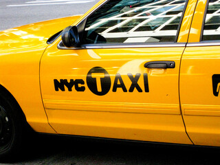 Close up of the side of a New York yellow taxi cab