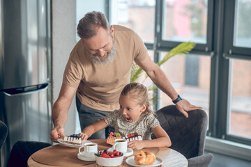 Dad and his daughter having breakfast together at home