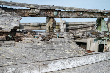 Close up of wooden frame and nails of abandoned fishing boat wreck at Dungeness, Kent, England