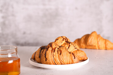 a fresh croissant with chocolate is on the table