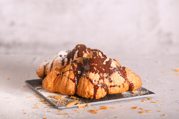 a fresh croissant with chocolate is on the table