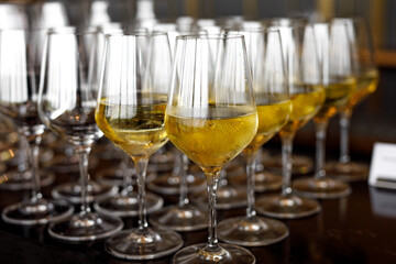 Glasses with white wine at an event.