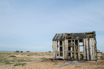 Abandoned and damaged wooden fishing shed at the beach of Dungeness, Kent, England