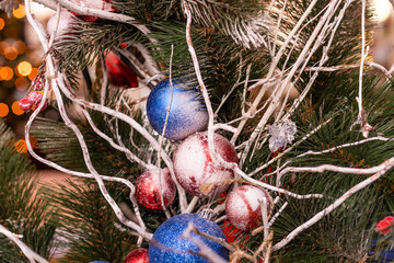 Streets fully decorated for Christmas with red and gold balls. Christmas tree in the city. House illuminated with a lot lights.