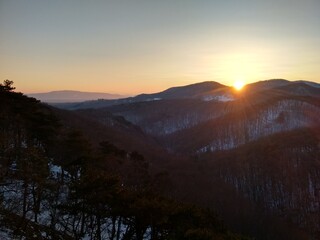 Stunning view: Wonderful winter moody sunset in an austrian forest landscape