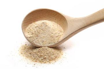 Ground bread crumbs pile in wooden spoon isolated on white  