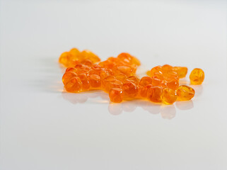 Fototapeta premium Fish caviar or roe on a white background, reflection in the base, rarity food, macro photos, many details.