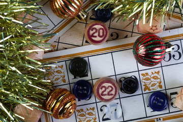 new Year's toys and numbers 2022 on the background of maps. the concept of the new year.A family board game of lotto. Cards and barrels with numbers. Play at home on a cold winter day.