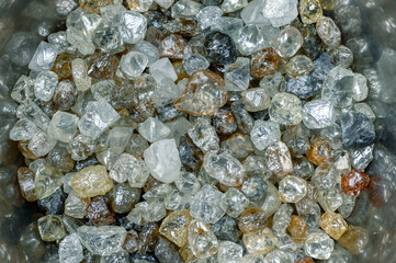 A scattering of various diamonds. Abstract background. Uncut gems, natural shape