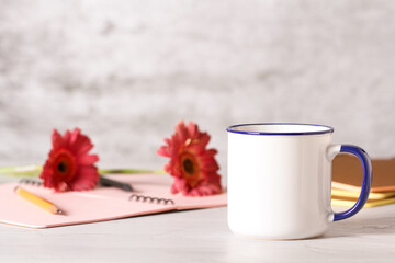 a mug of tea is on the desktop in the office