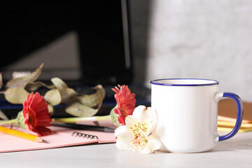 a mug of tea is on the desktop in the office