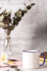 a mug of tea is on the desktop in the office