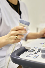 The doctor holds in his hand a device for ultrasound examination of human internal organs.