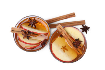 Hot mulled cider and ingredients on white background, top view