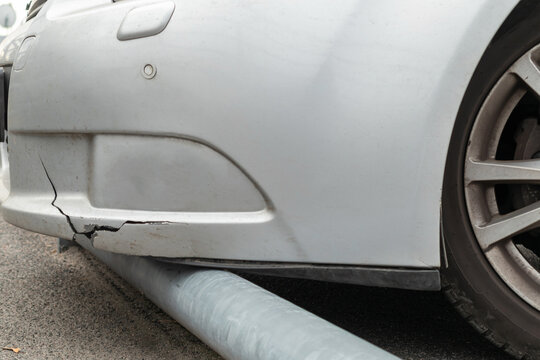 Broken Car Bumper Crashing Into Parking Curb