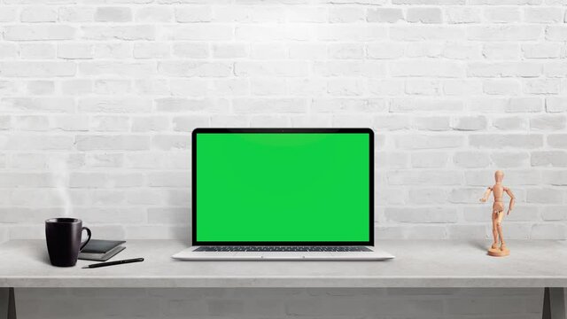 Laptop computer mockup on work desk. Isolated display in chroma key green for web site design presentation
