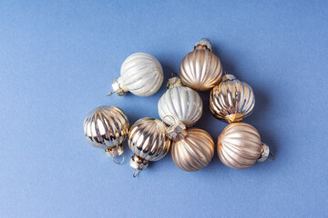 Group of small Christmas balls on blue background. Happy New year and Christmas 2022 celebration