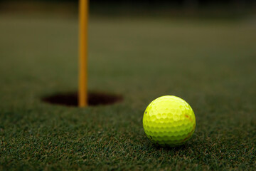 Golf ball near the hole.