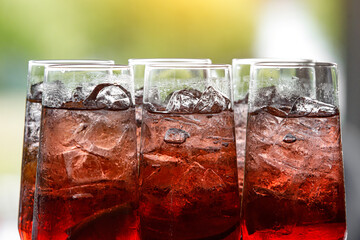 Glass of red lemonade with ice.