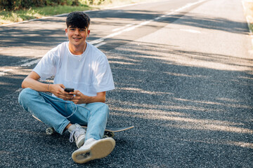 Obraz premium boy with skateboard and headphones on the road