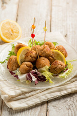 salmon meatballs with lemon and salad