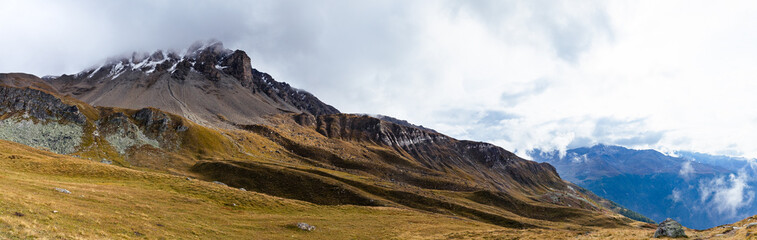 Panorama of a Swiss mountain on a cloudy sky in Wallis