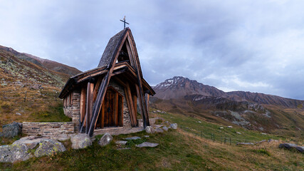 Panorama of a chapel in the mountains of Switzerland on a cloudy sky