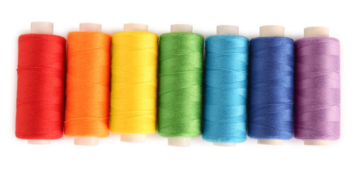 Set of colorful sewing threads on white background, top view