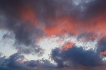 Beautiful sunset sky. Clouds illuminated by red sunlight at sunset. This view of the sky with clouds at sunset is great for background and design.