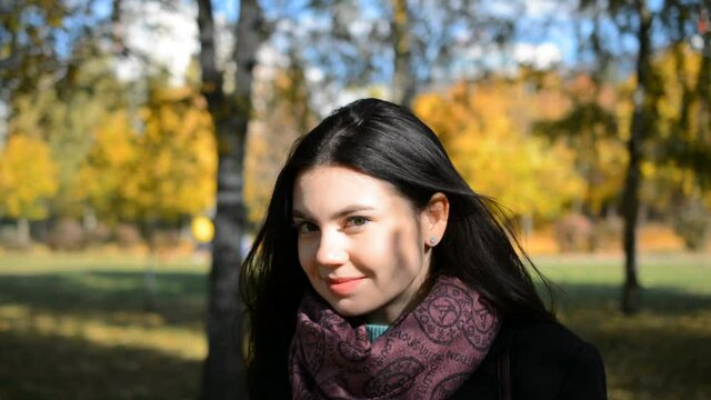 Beautiful brunette girl portrait smiling in autumn park