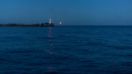 Night view of the lighthouse and the moon