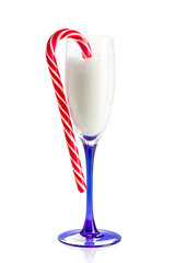 Champagne glass full of fluffy snow with candy cane on edge. Isolated on white background with reflection. Concept of Merry Christmas and Happy New Year.