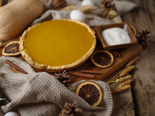 Stylish hand-made composition - pumpkin pie, decor, ingredients and kitchen utensils. Lots of facilities. No people. Postcard, invitation, banner, menu design.