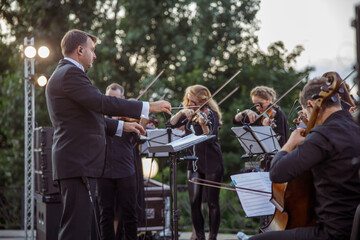 Musical ensemble playing classic instrumental music outdoors