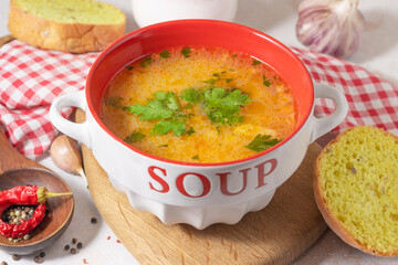 kharcho soup with greens in a white and red plate