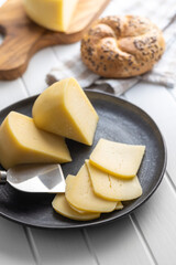 Block of hard cheese. Sliced cheese.