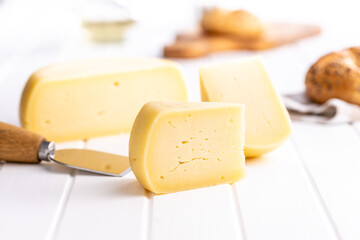 Block of hard cheese. Sliced cheese.