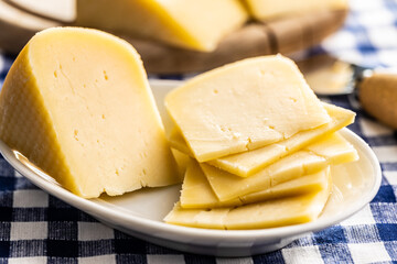 Block of hard cheese. Sliced cheese.