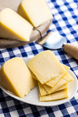 Block of hard cheese. Sliced cheese.